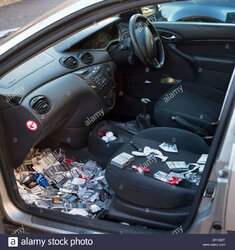 many-discarded-cigarette-packets-thrown-on-the-floor-of-a-ford-focus-DR1DDT.jpg